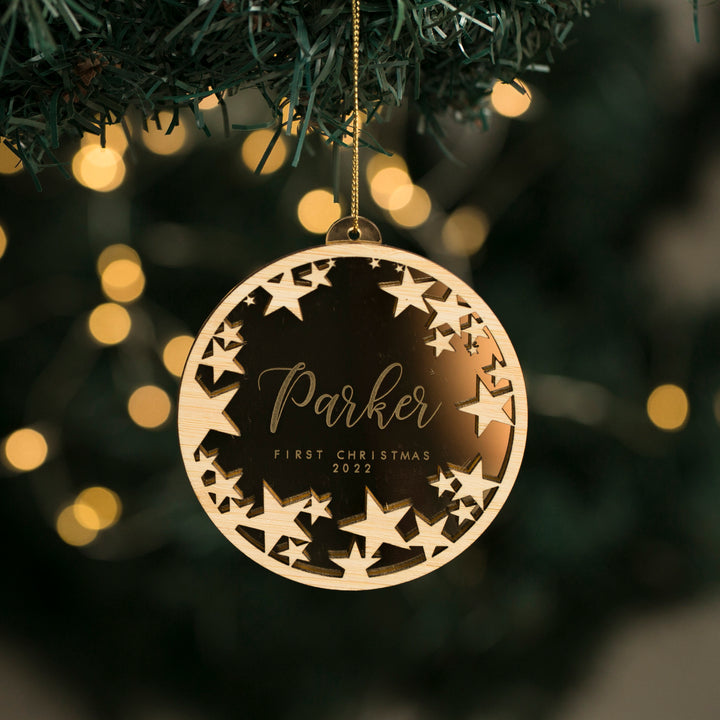 A personalized Christmas bauble with a starry night design, featuring a mirrored acrylic base with the name &