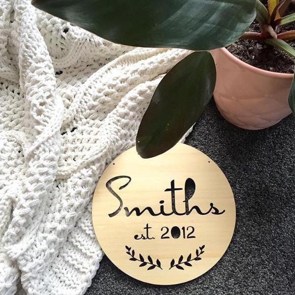 A round bamboo Personalised Surname Plaque engraved with a custom family surname, handcrafted in New Zealand by Love from Seventeen.
