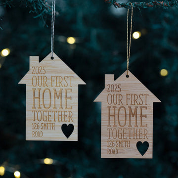 Two wooden house-shaped ornaments with &