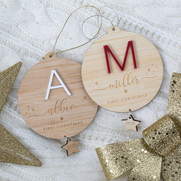 Two wooden Christmas ornaments with engraved names and &