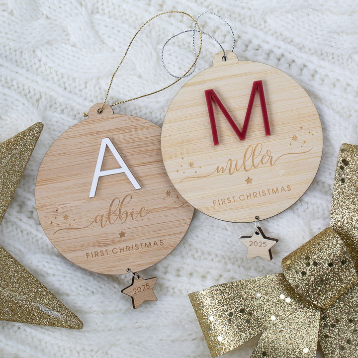 Two wooden Christmas ornaments with engraved names and &