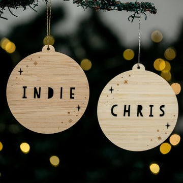 Two wooden ornaments with &