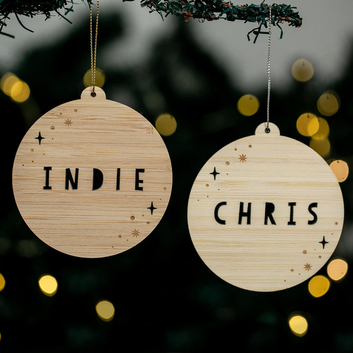 Two wooden ornaments with &