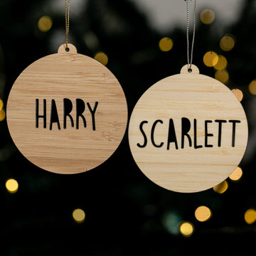 Two wooden ornaments with &