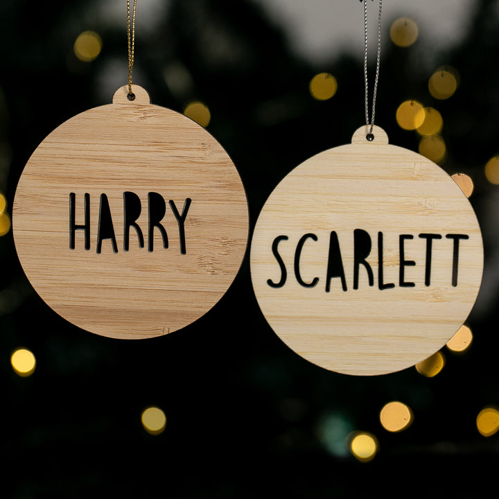 Two wooden ornaments with &