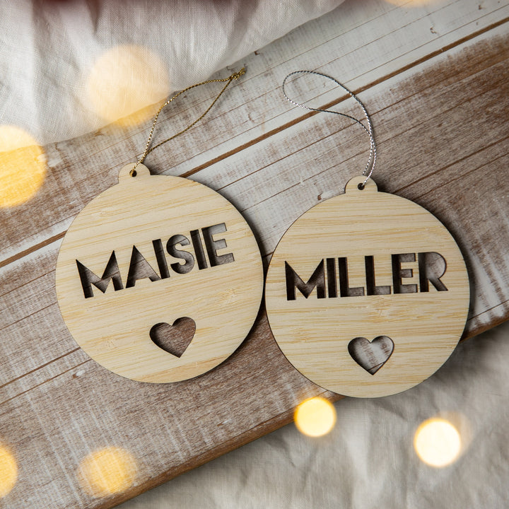 Two wooden ornaments with engraved names &
