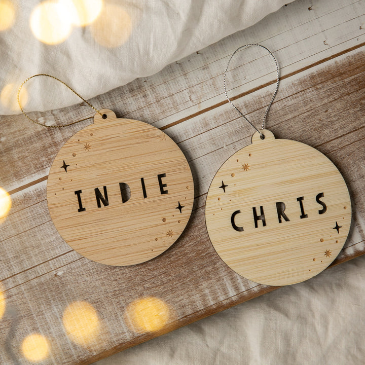 Two wooden ornaments with &
