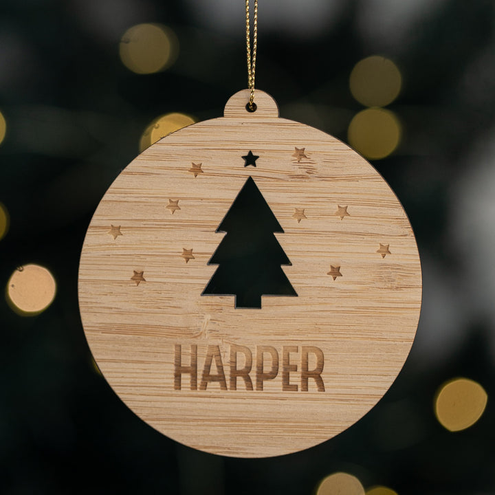 Wooden ornament with a tree silhouette and &