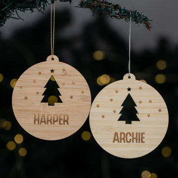 Two wooden Christmas ornaments with tree designs and names &