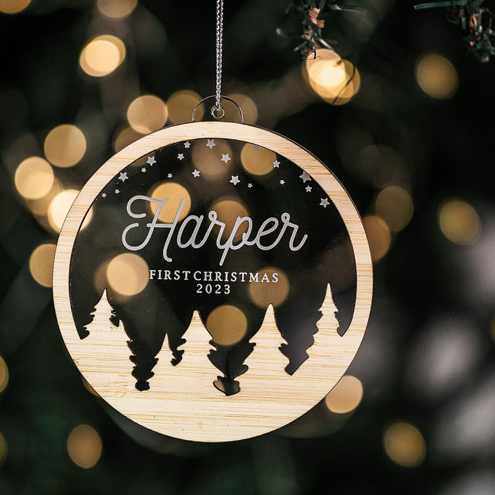 A personalized snow globe with a clear acrylic base featuring engraved name and &