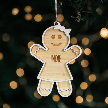 A personalized hanging ornament shaped like a gingerbread man with the name &
