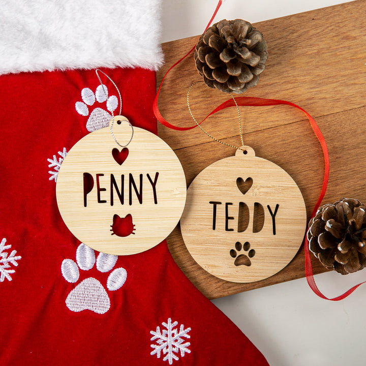 Two wooden ornaments with &