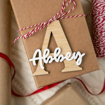 Gift box wrapped in brown paper with a wooden letter &