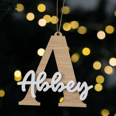 Wooden letter 'A' with 'Albey' in white on a blurred lights background