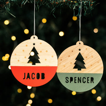 Two personalized woodland Christmas baubles with the names &
