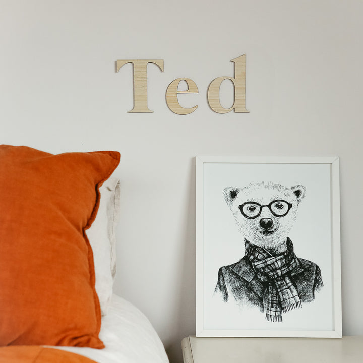 Bamboo classic wall lettering saying Ted. Hanging on the wall of a child&