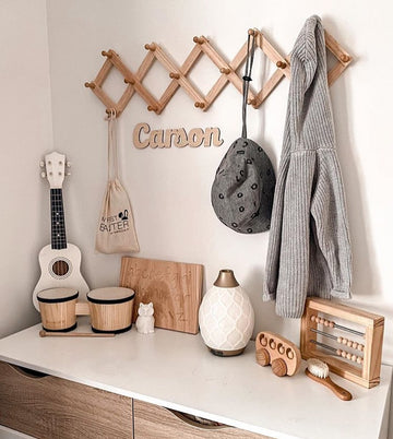 A bamboo wall name saying Carson, hanging in a children&