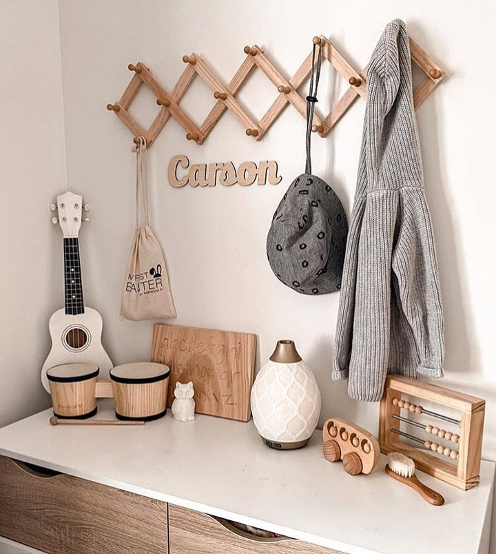 A bamboo wall name saying Carson, hanging in a children&