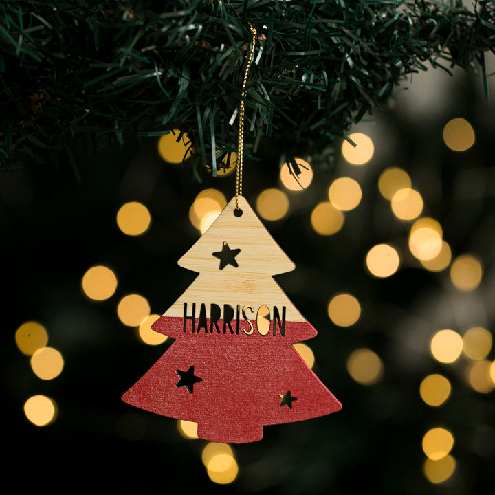 A red and white Christmas tree-shaped decoration with the name &