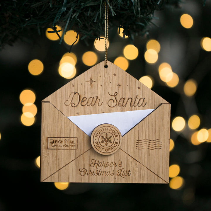 A personalized letter to Santa Claus Christmas ornament with a slot for a letter, decorated with holiday lights and festive design.