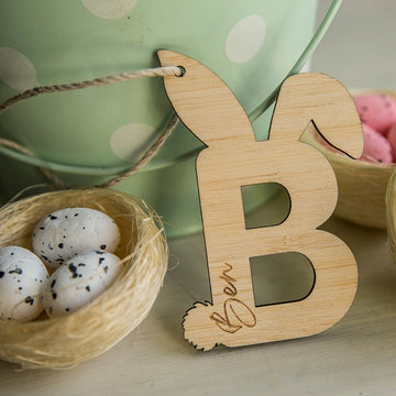 A Personalised Easter Letter B from our eco-friendly collection, featuring bunny ears and tail and engraved with Ben&