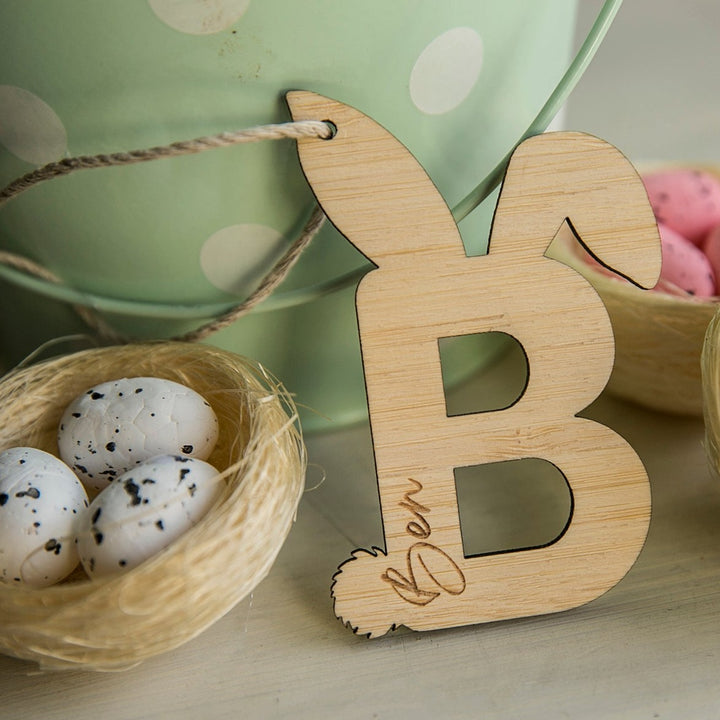 A Personalised Easter Letter B from our eco-friendly collection, featuring bunny ears and tail and engraved with Ben&