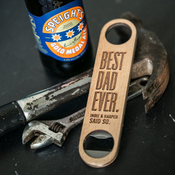 The Personalised Bottle Opener (3 designs available), engraved with “Best Dad Ever. Indie & Harper said so.”, sits on a hammer and wrench beside a Speight’s Gold Medal Ale—perfect for men who value both meaning and function.