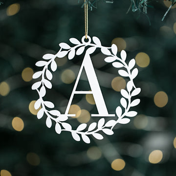 A white bauble with a serif initial &