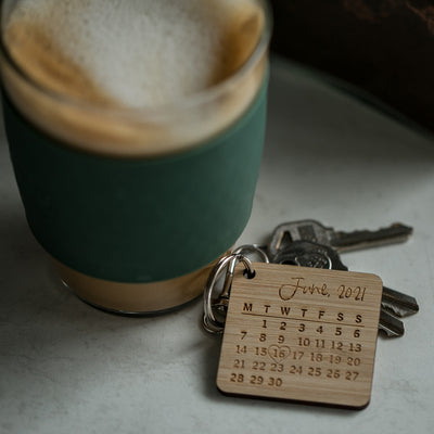 Bamboo keyring with a monthly calendar of June 2021, with a love heart around the 16th.