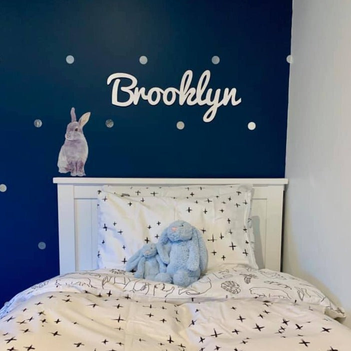A bamboo wall name saying Brooklyn, hanging in a boys bedroom. 