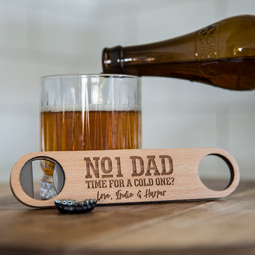 A Personalised Bottle Opener (3 designs available), engraved with "No1 Dad, Time for a cold one? Love, Indie & Harper," is pictured beside a glass of beer being poured—making it the perfect gift for men.