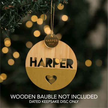 A gold keepsake disc reading HARPER 2022 hangs above a round wooden ornament with HARPER cut out and a heart below. Text: Keepsake Discs for Baubles (bauble not included); dated disc only, wooden bauble not included.