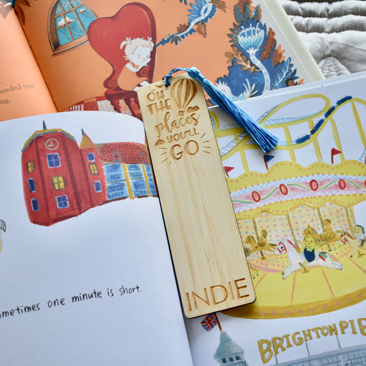 A light bamboo bookmark with blue tassel, inscription reading Oh the places you&