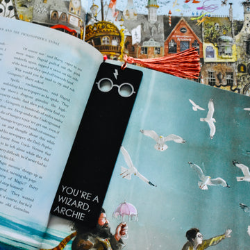 A black acrylic bookmark with Harry Potter glasses and scar etched at the end, with the words You&