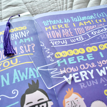 A clear bookmark, with purple tassel, and the name Marnie etched on in signature style writing.