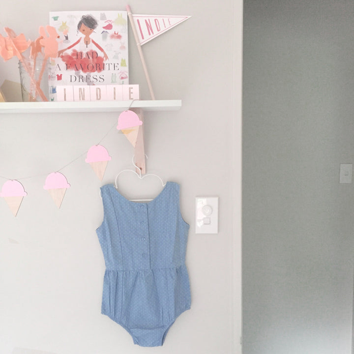 A light bamboo garland with 4 icecreams, each painted pink. Hanging in a child&